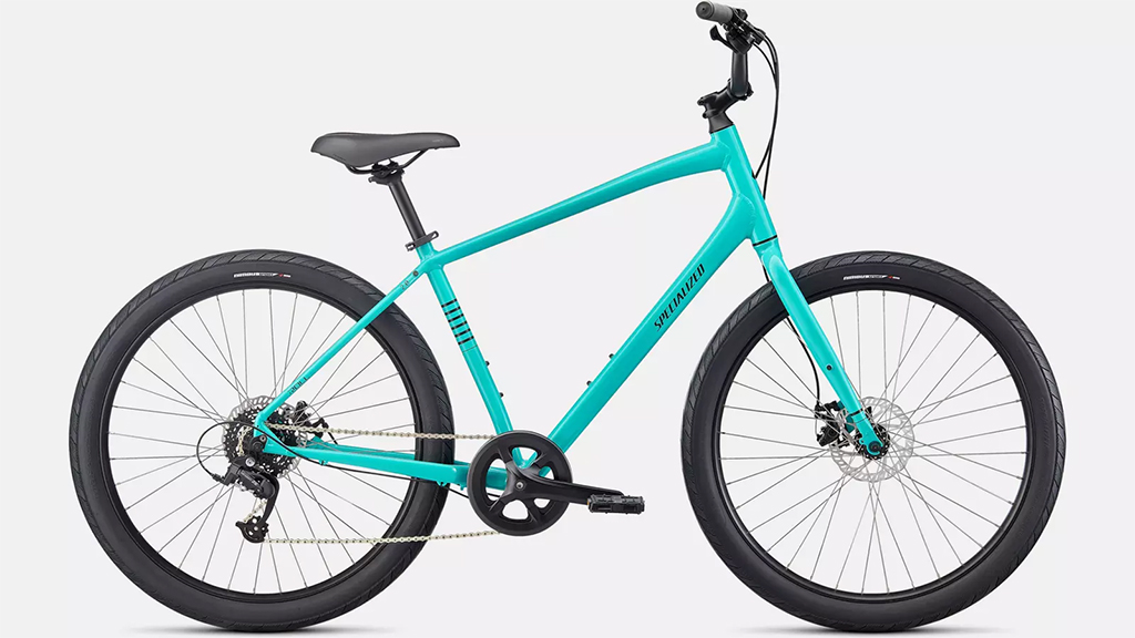 A Specialized/iZip Men's Bike in turquoise with thick tires, disc brakes, and a straight handlebar on a white background.