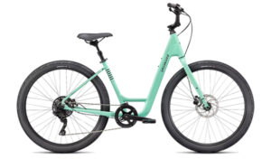 The Specialized/iZip Womens Bike is a light blue step-through with wide tires, disc brakes, and a simple gear system.
