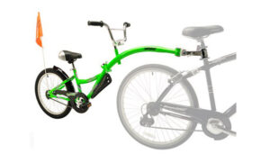 The Tag-a-Long W/ Adult Bike is a green child's one-wheel trailer with an orange safety flag that attaches to an adult bike.