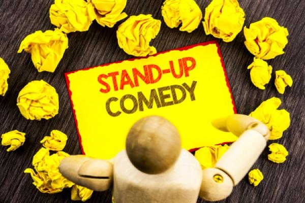 A gold sign reads "Stand Up Comedy"