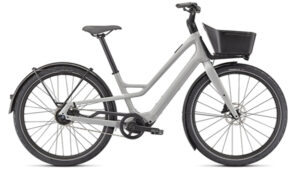 The Specialized Turbo Como SL 4.0 e-Bike is gray with a front basket, fenders, and wide tires, shown in side profile.