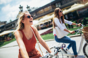 Two beautiful women shopping on bike in the city